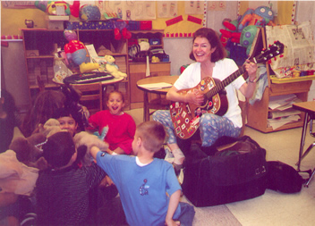 Lydia with preschool children working on writing songs